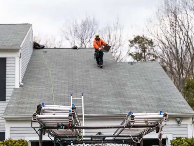 Man walking on Roof Shingles
