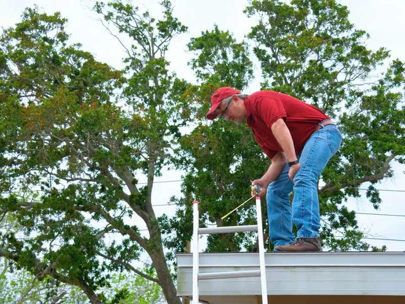 Person inspecting a new roof