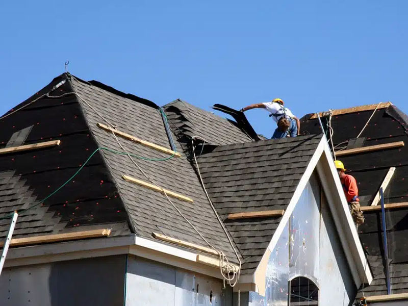Workers Putting Shingles on Roof
